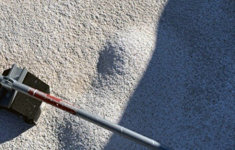 Foam roofing surface with impact damage and texture variation requiring inspection evaluation