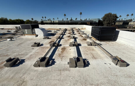 Commercial roof inspection of flat roofing system in Phoenix AZ with equipment mounts, drainage paths, and coating condition under evaluation
