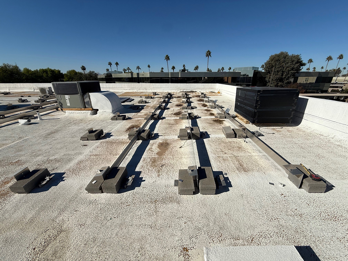 Commercial roof inspection of flat roofing system in Phoenix AZ with equipment mounts, drainage paths, and coating condition under evaluation