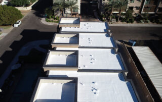 Commercial foam roof with white protective coating on an Arizona flat roof building
