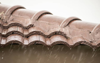 MSW Contracting roofer inspecting a storm-related roof leak after heavy rain in Chandler and Scottsdale, Arizona